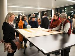 Attendees examining the quilt.