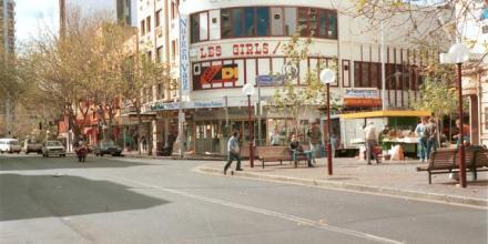 a streetscape showing a venue called Les Girls