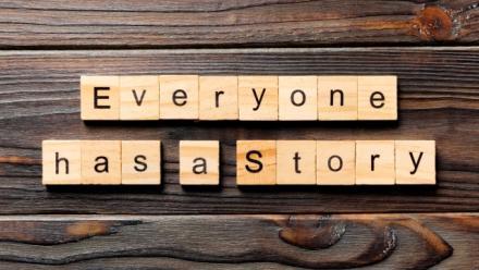 Everyone Has a Story word written on wood block, on top of wooden table