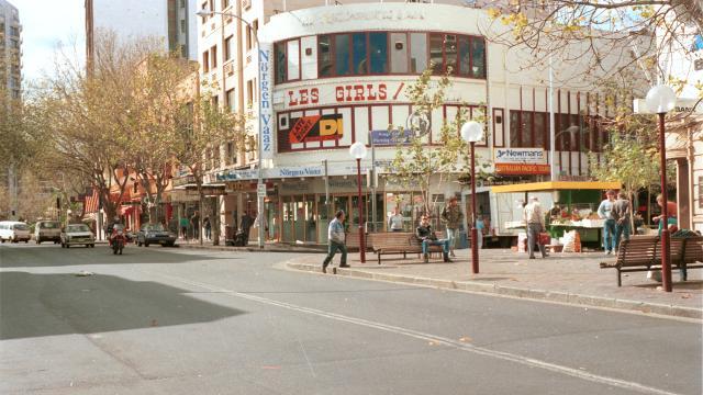 a streetscape showing a venue called Les Girls